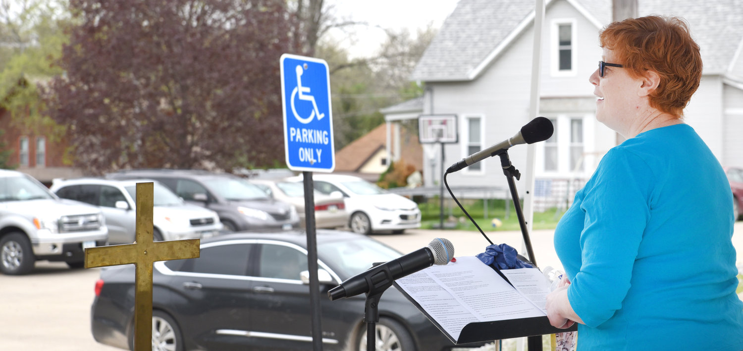 The Rev. Melissa Warren preaches in the parking lot of her church Sunday. Parishioners attended in about 15 vehicles. Just like in regular services, the back row filled up first.